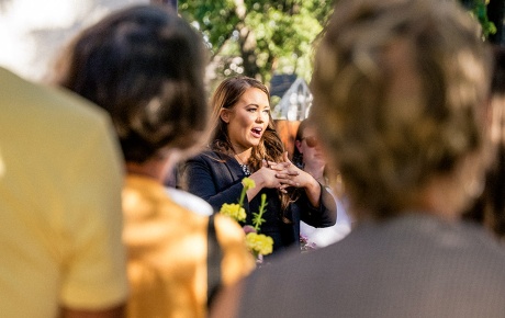 Cara Mund is speaking to a crowd. 