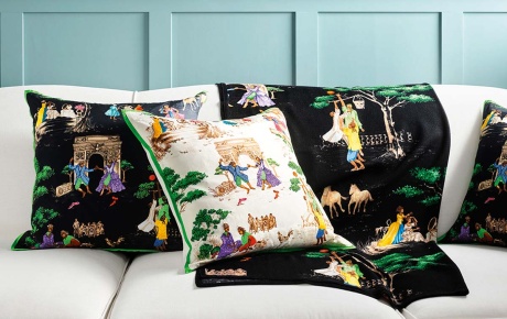 Image of Sheila Bridge's designs on pillows and blankets on a couch.