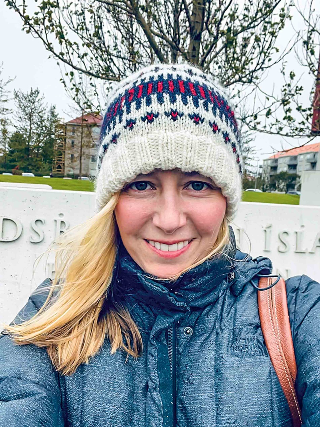 Image of Jenna Grace Sciuto wearing a hat and smiling at the camera