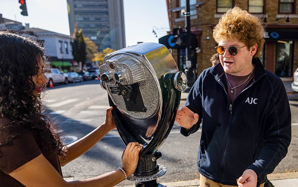 Image of Daniel  Solomon &rsquo;26 working on The Blind Urban Subject installation on a Providence street. 