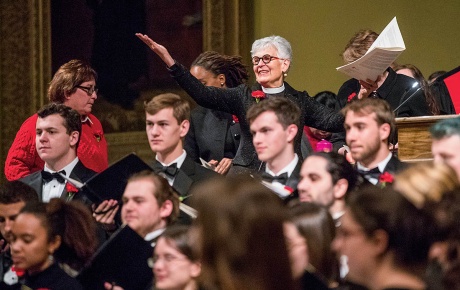 An image of Janet Cooper Nelson with students in tuxes in the foreground