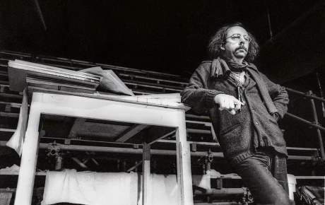 Archival image of Richard Foreman leaning on stage