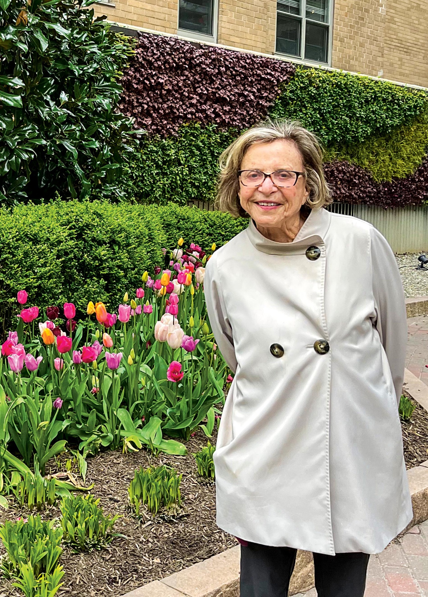 Image of Phyllis Whitman Beck in front of tulips